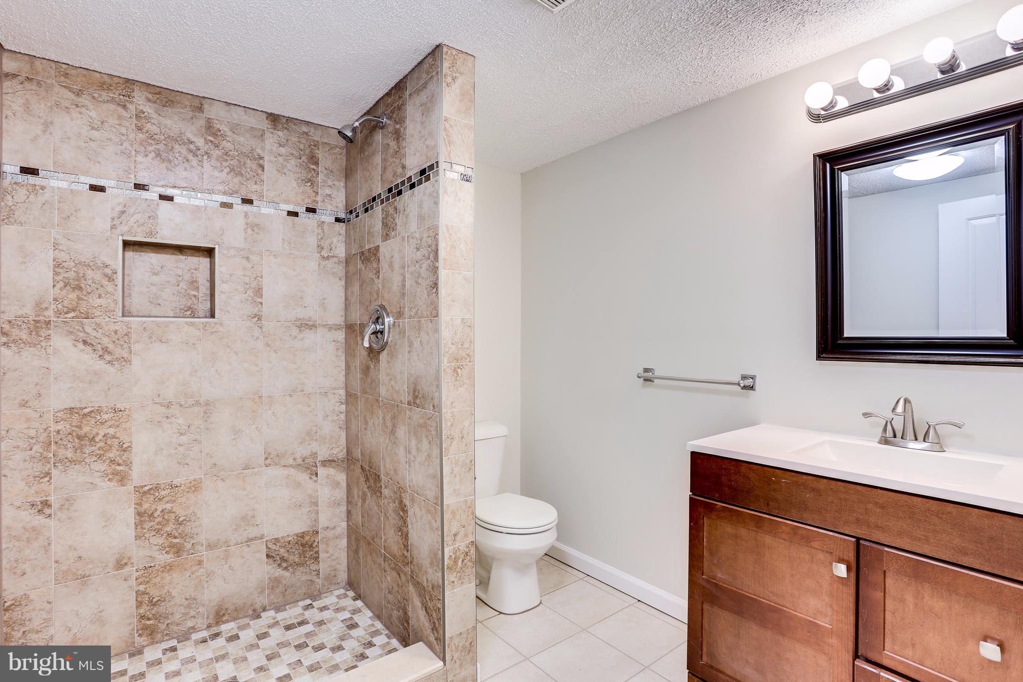 15407 Rowland Lane Silver Spring, MD 20905 - Photo 17 of 29 a bathroom with a sink a toilet and shower