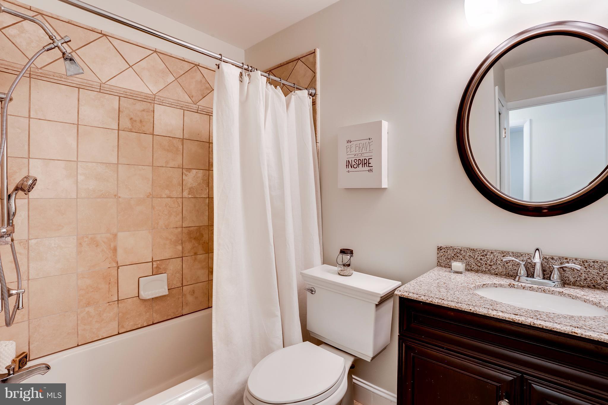 15407 Rowland Lane Silver Spring, MD 20905 - Photo 20 of 29 a bathroom with a granite countertop sink and a mirror