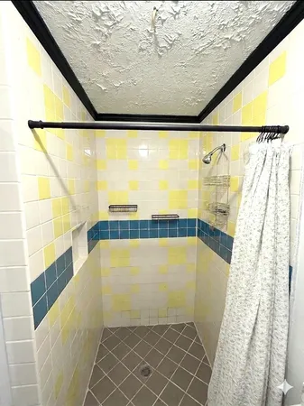 a view of bathroom with shower and bathtub