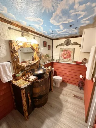 a bedroom with a bed and a flat tv screen on a dresser