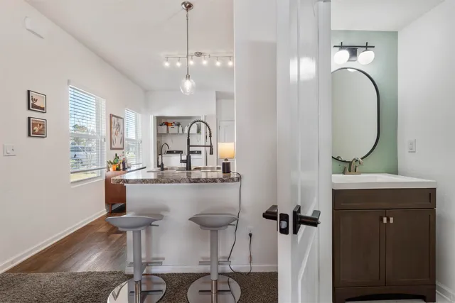 a kitchen with stainless steel appliances granite countertop a sink refrigerator and cabinets