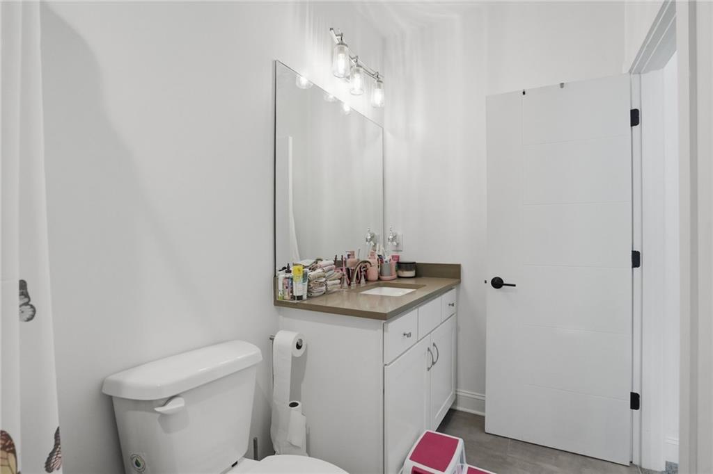 3020 Wallace Road Buford, GA 30519 - Photo 43 of 66 a bathroom with a toilet sink and mirror