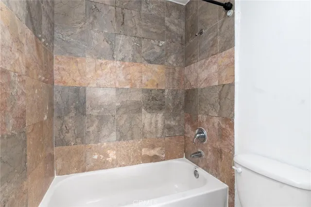 a bath tub sitting next to a white sink and vanity