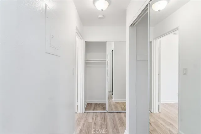 a view of a hallway with wooden floor