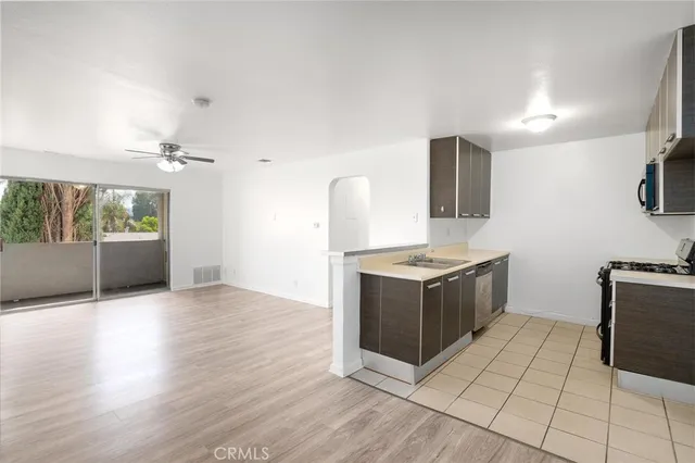 a kitchen with granite countertop a stove top oven and sink