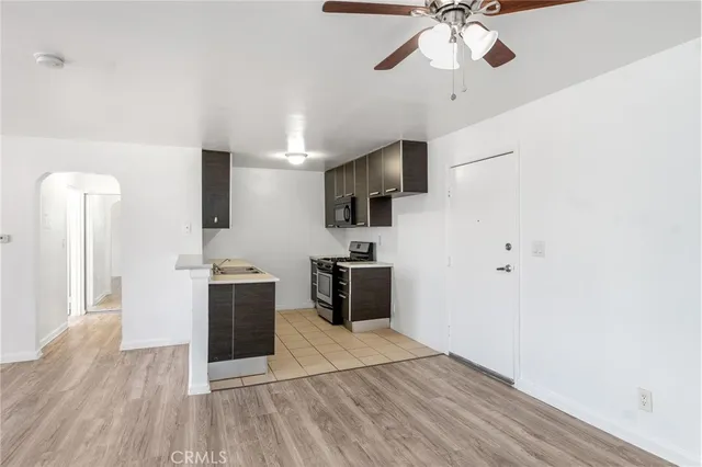 a kitchen with stainless steel appliances kitchen island granite countertop a stove a sink and a refrigerator