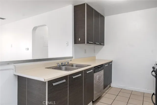 a utility room with sink and cabinets