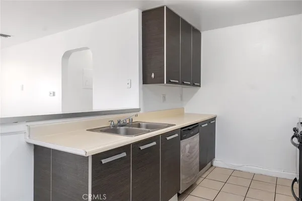 a utility room with sink and cabinets