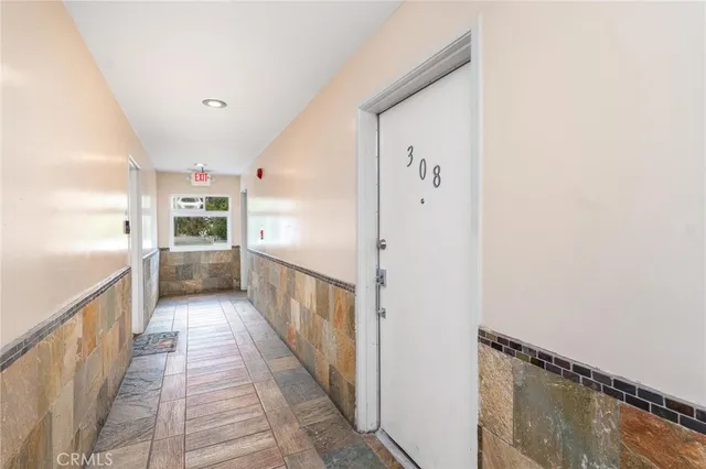a kitchen with cabinets and wooden floor
