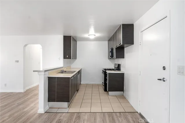 a kitchen with granite countertop a stove and a refrigerator