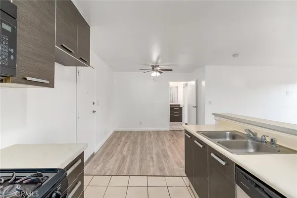 a kitchen with a sink cabinets and appliances