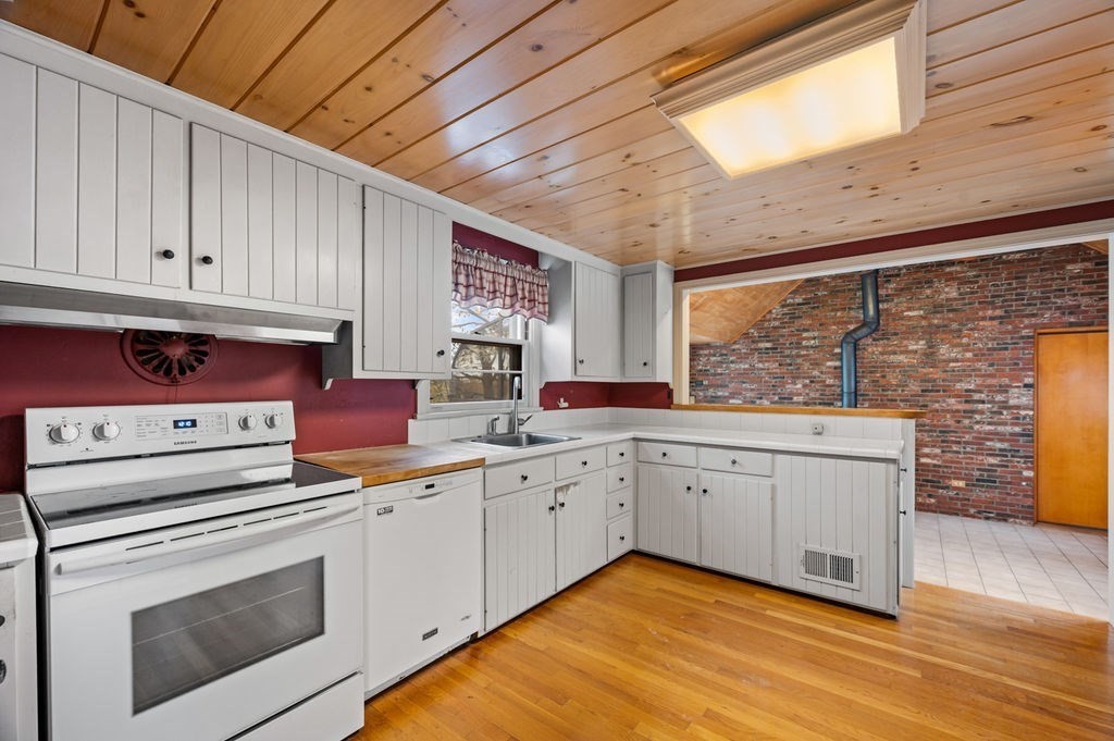 10 Standish Way Lynn, MA 01904 - Photo 12 of 41 a kitchen that has a sink and a stove