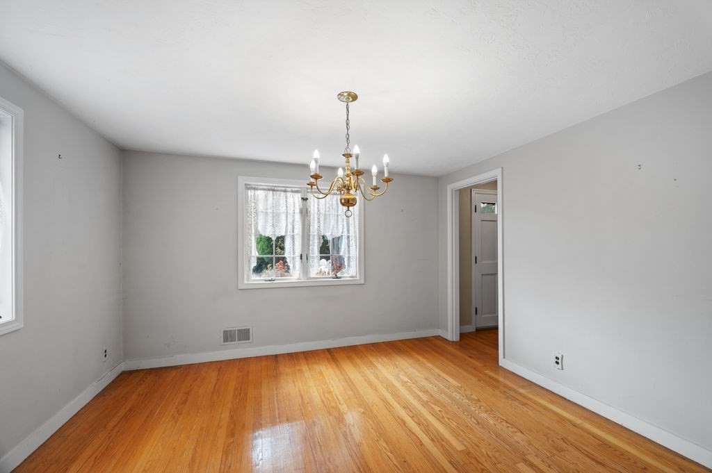 10 Standish Way Lynn, MA 01904 - Photo 14 of 41 a view of empty room with wooden floor and chandelier