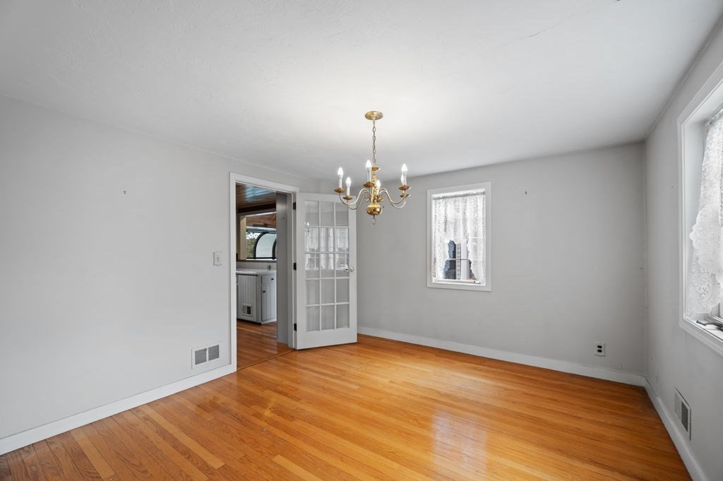 10 Standish Way Lynn, MA 01904 - Photo 15 of 41 an empty room with wooden floor chandelier and windows