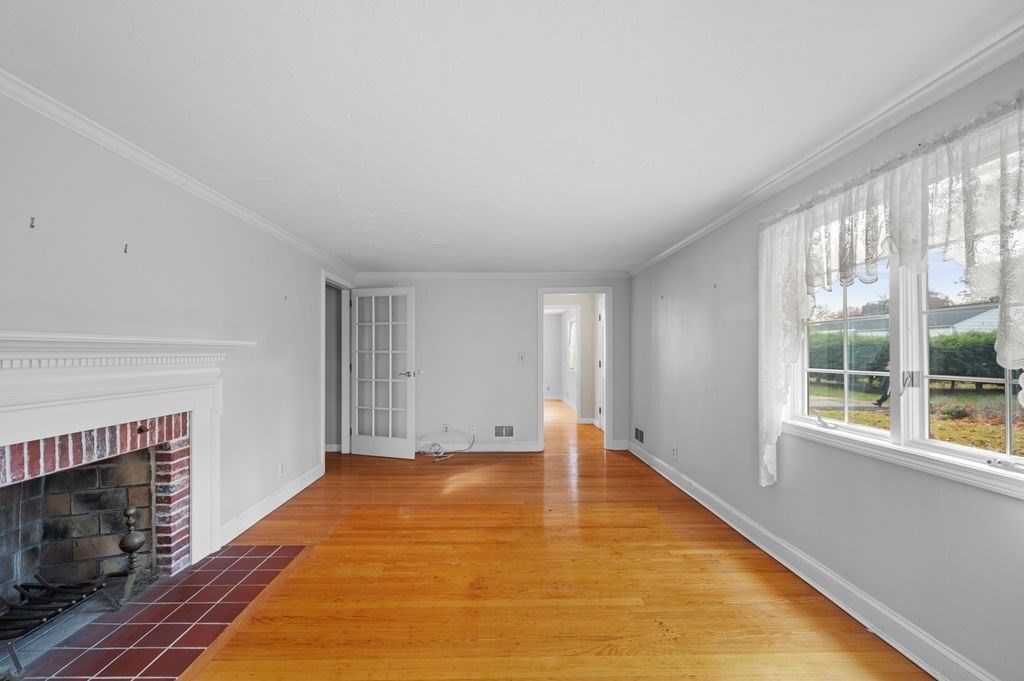 10 Standish Way Lynn, MA 01904 - Photo 19 of 41 a view of an empty room with a fireplace and a window