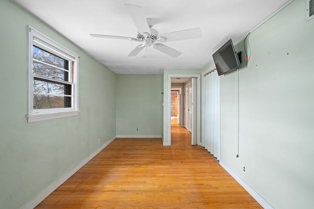 10 Standish Way Lynn, MA 01904 - Photo 21 of 41 a view of an empty room with wooden floor and a ceiling fan