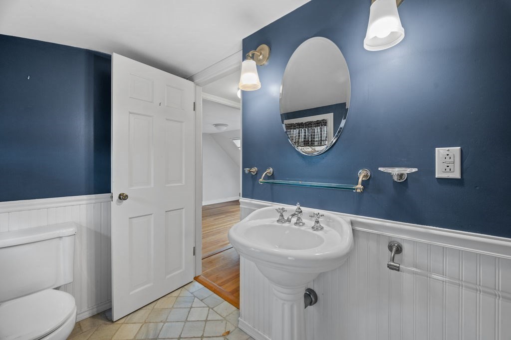 10 Standish Way Lynn, MA 01904 - Photo 30 of 41 a bathroom with a toilet sink and mirror