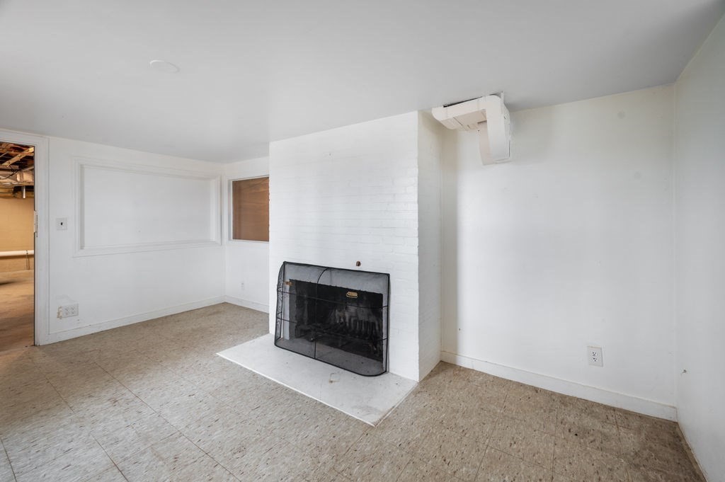 10 Standish Way Lynn, MA 01904 - Photo 33 of 41 a living room with a fireplace and a flat screen tv