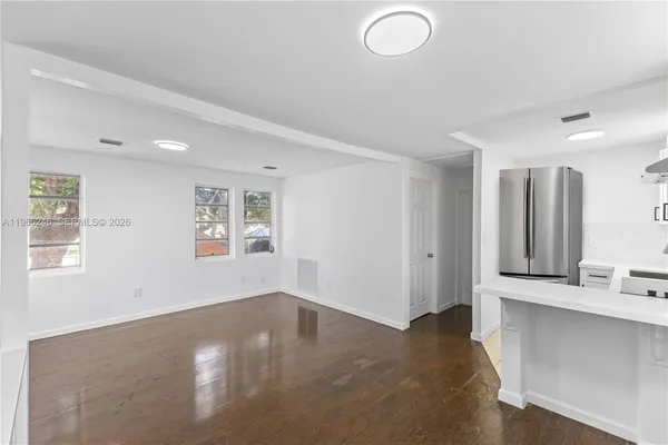 a view of a livingroom with wooden floor and a window