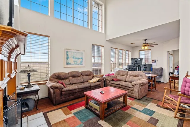 a living room with furniture a rug and a window