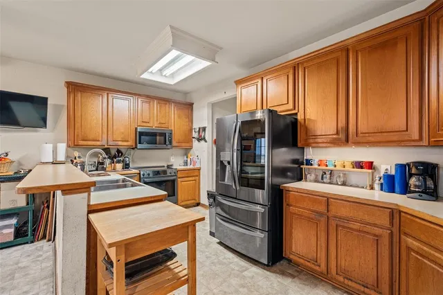a kitchen with stainless steel appliances cabinets a stove and a refrigerator