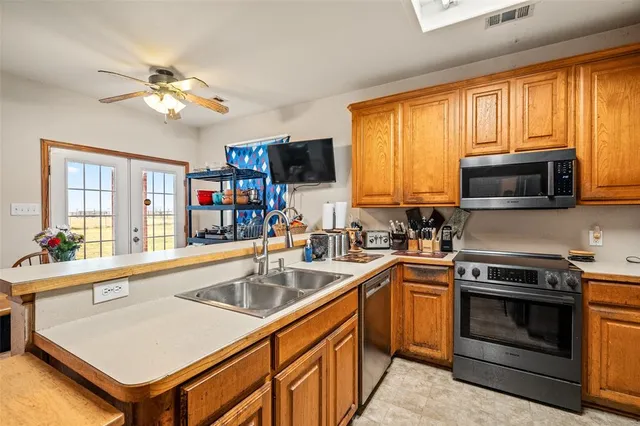 a kitchen with a stove a sink and a microwave