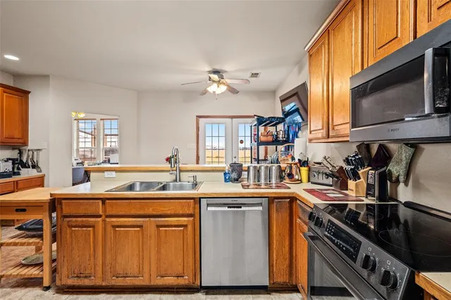a kitchen with stainless steel appliances a sink stove and cabinets