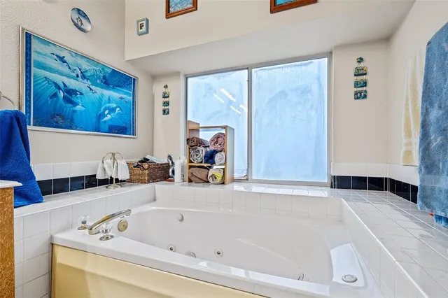 a bathroom with a bathtub and a window