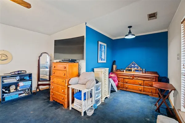 a bed room with furniture and a flat screen tv