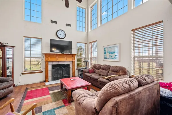 a living room with furniture a fireplace and windows