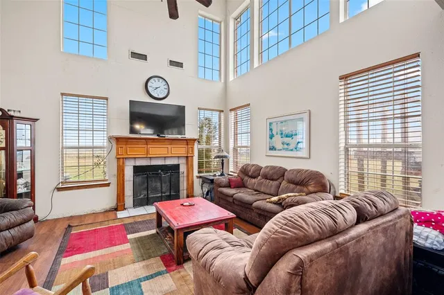 a living room with furniture a fireplace and windows