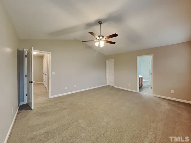 a view of an empty room with a ceiling fan