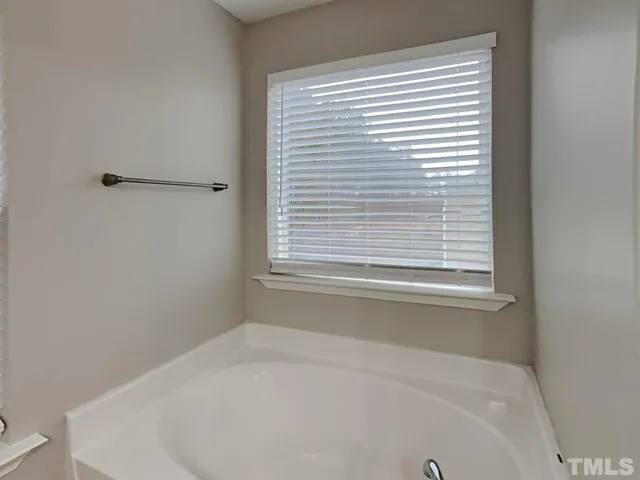 a white bath tub sitting next to a window