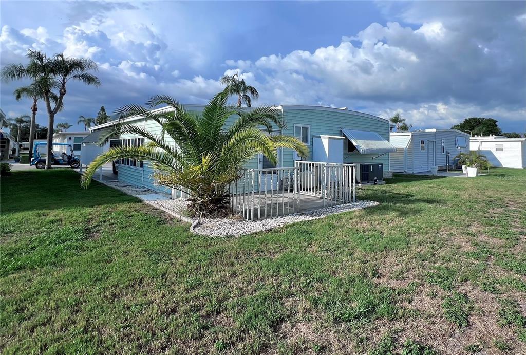 1100 South Belcher Road, Unit 772 Largo, FL 33771 - Photo 49 of 84 a view of a house with a big yard plants and large trees