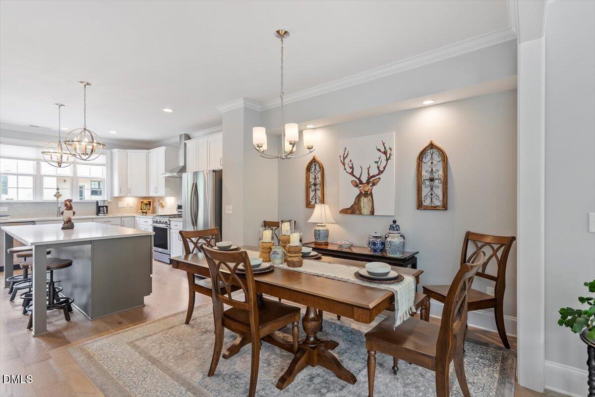 1601 Bowery Drive Raleigh, NC 27607 - Photo 13 of 41 a view of a dining room with furniture and chandelier