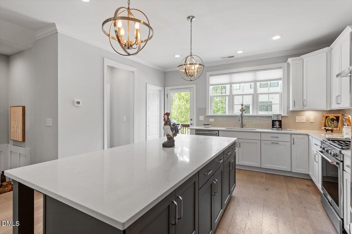 1601 Bowery Drive Raleigh, NC 27607 - Photo 18 of 41 a large kitchen with stainless steel appliances a large center island attached withe living room