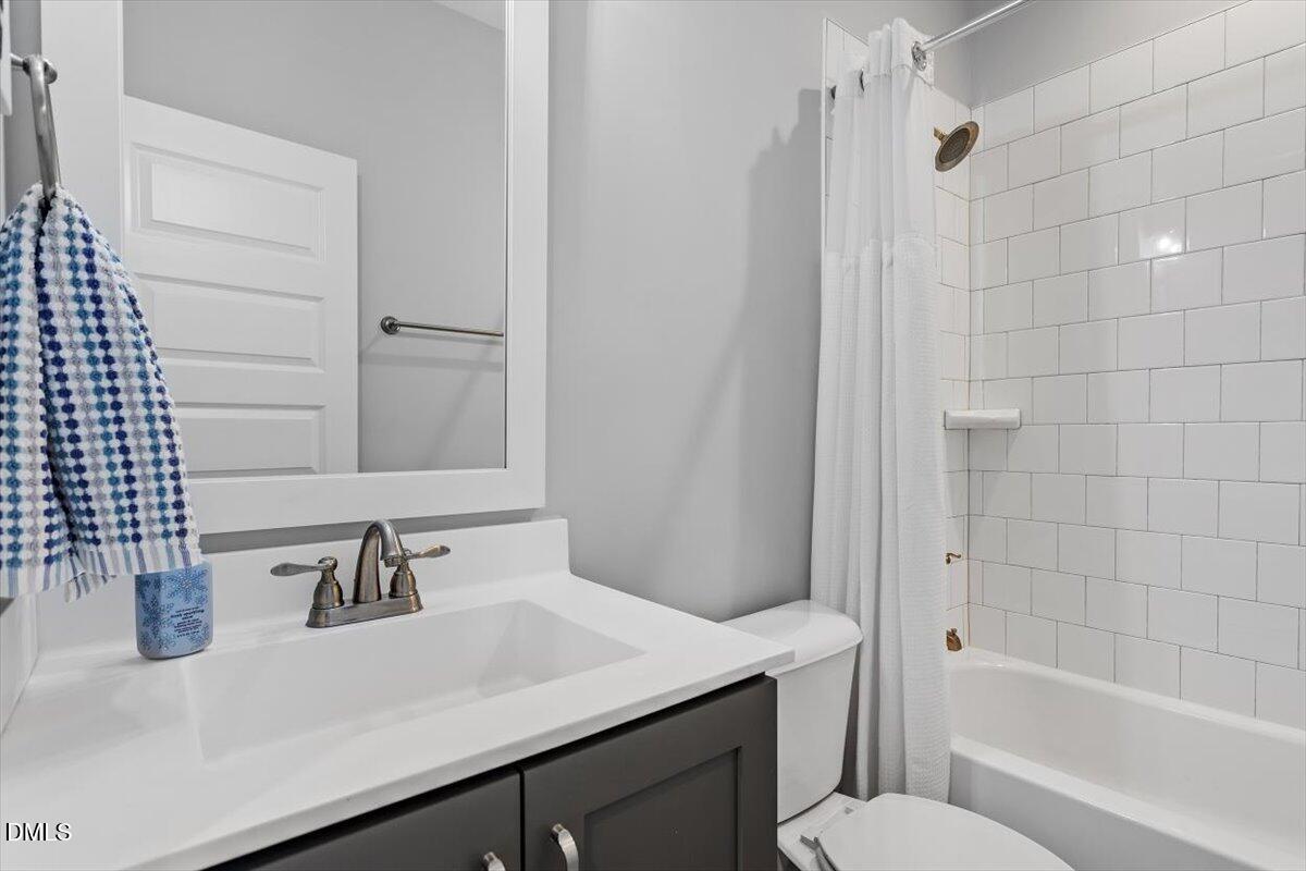 1601 Bowery Drive Raleigh, NC 27607 - Photo 24 of 41 a bathroom with a sink toilet vanity and shower