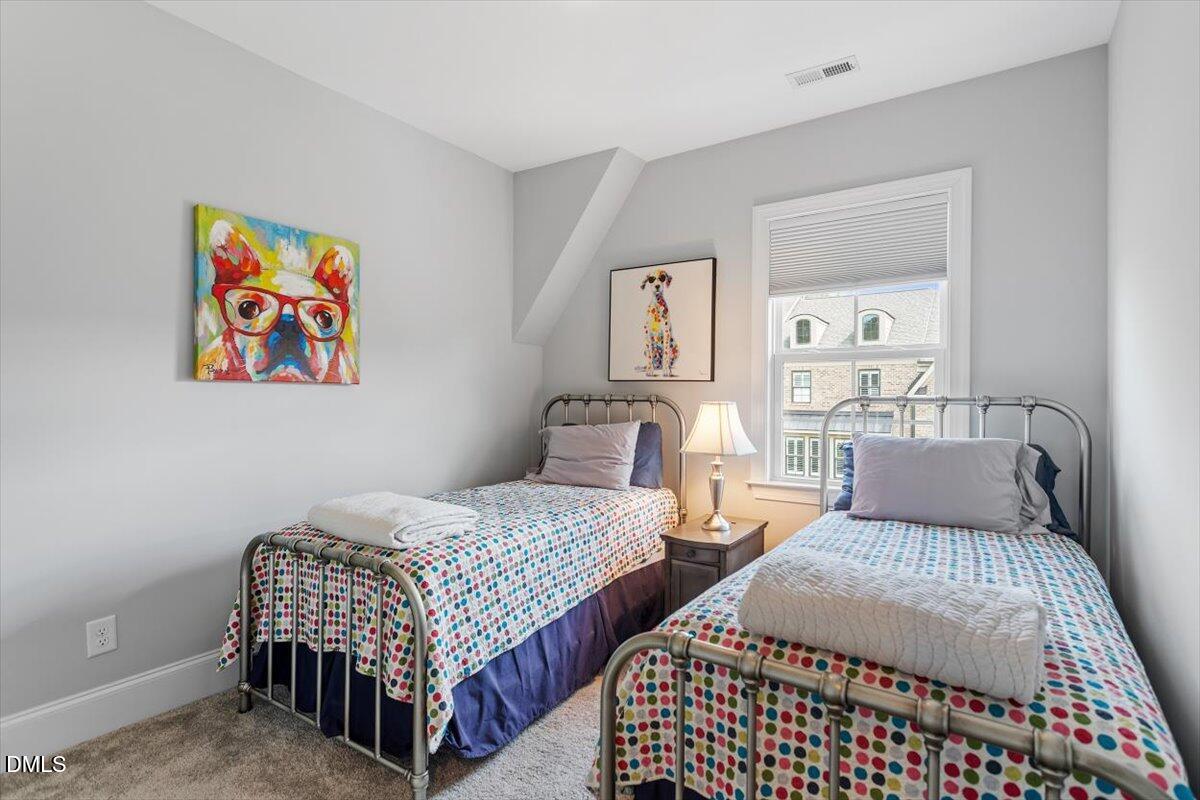 1601 Bowery Drive Raleigh, NC 27607 - Photo 25 of 41 a bedroom with two beds and painting on the wall