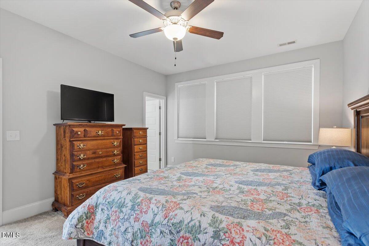 1601 Bowery Drive Raleigh, NC 27607 - Photo 28 of 41 a bedroom with a bed and a flat screen tv