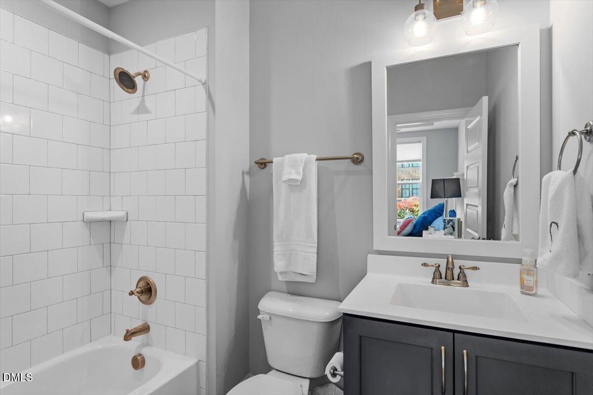 1601 Bowery Drive Raleigh, NC 27607 - Photo 7 of 41 a bathroom with a sink a toilet and shower a mirror