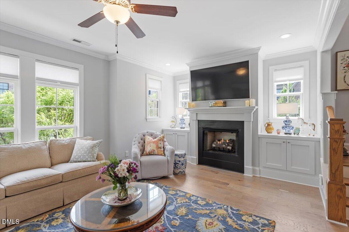 1601 Bowery Drive Raleigh, NC 27607 - Photo 8 of 41 a living room with furniture a fireplace and a flat screen tv