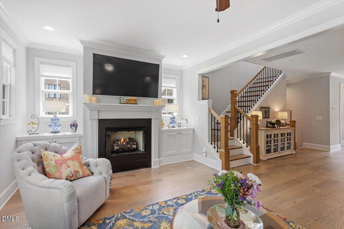 1601 Bowery Drive Raleigh, NC 27607 - Photo 9 of 41 a living room with furniture a flat screen tv and a fireplace