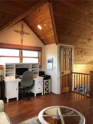 a spacious bedroom with a bed a couch and a window