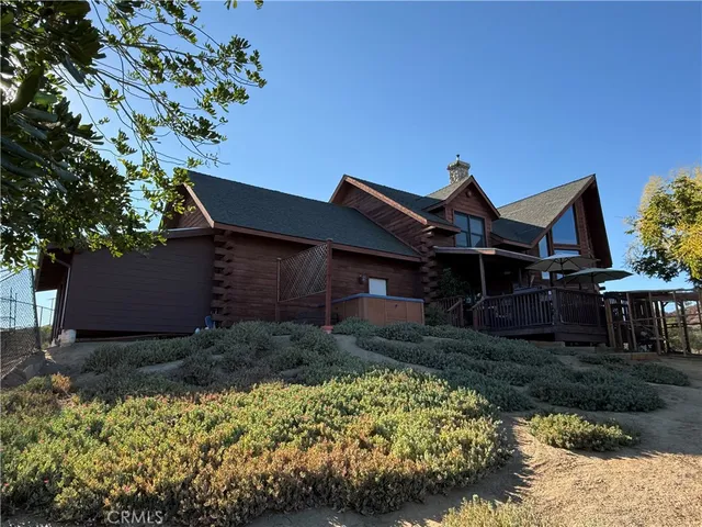 an aerial view of a house with a mountain