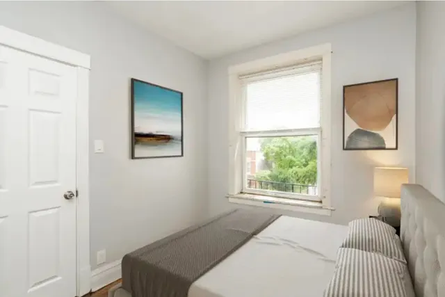 a bedroom with a bed and a window