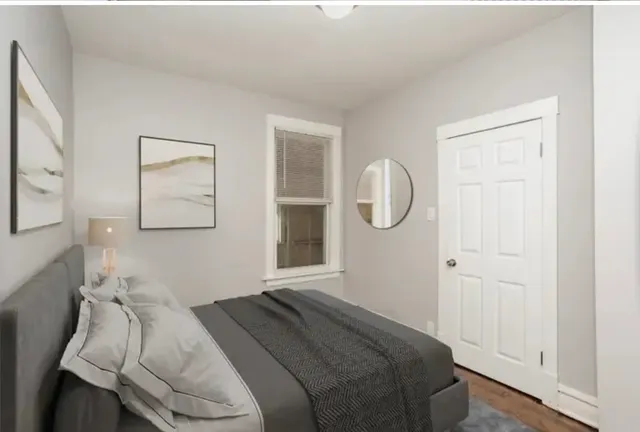 a bedroom with a bed and a mirror