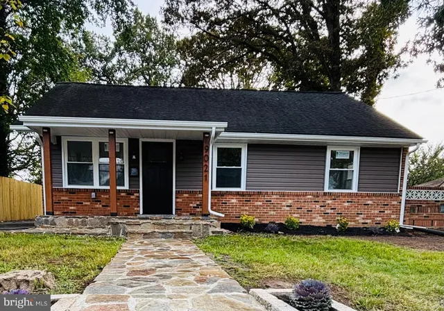 a view of house with a yard