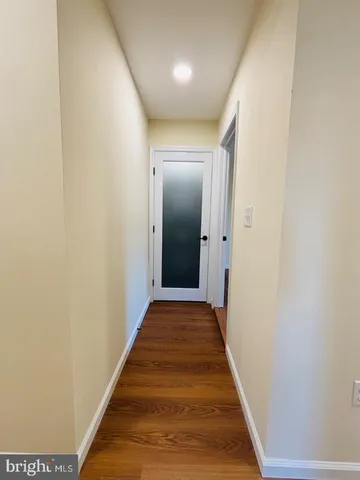 a view of hallway with wooden floor