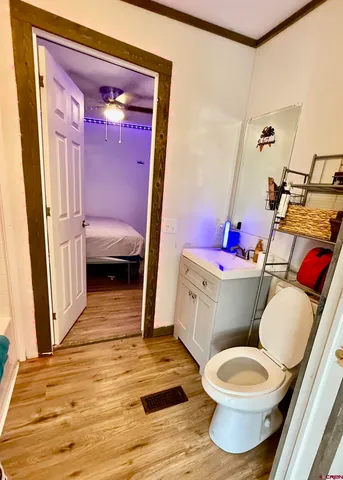 a bathroom with a sink toilet and mirror