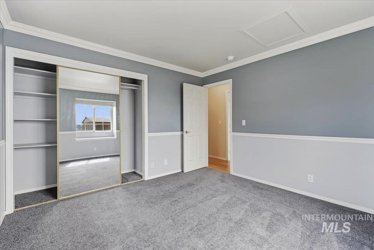 7900 Labor Camp Road Caldwell, ID 83607 - Photo 19 of 45 Vaulted ceilings, bay window, chandelier, wood-finish flooring, and arched window feature